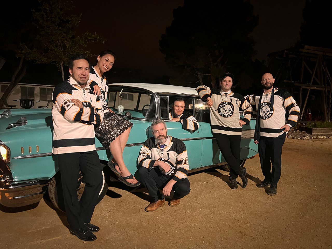 The Morning Spins in their Flying Elbows jerseys in and around a classic car